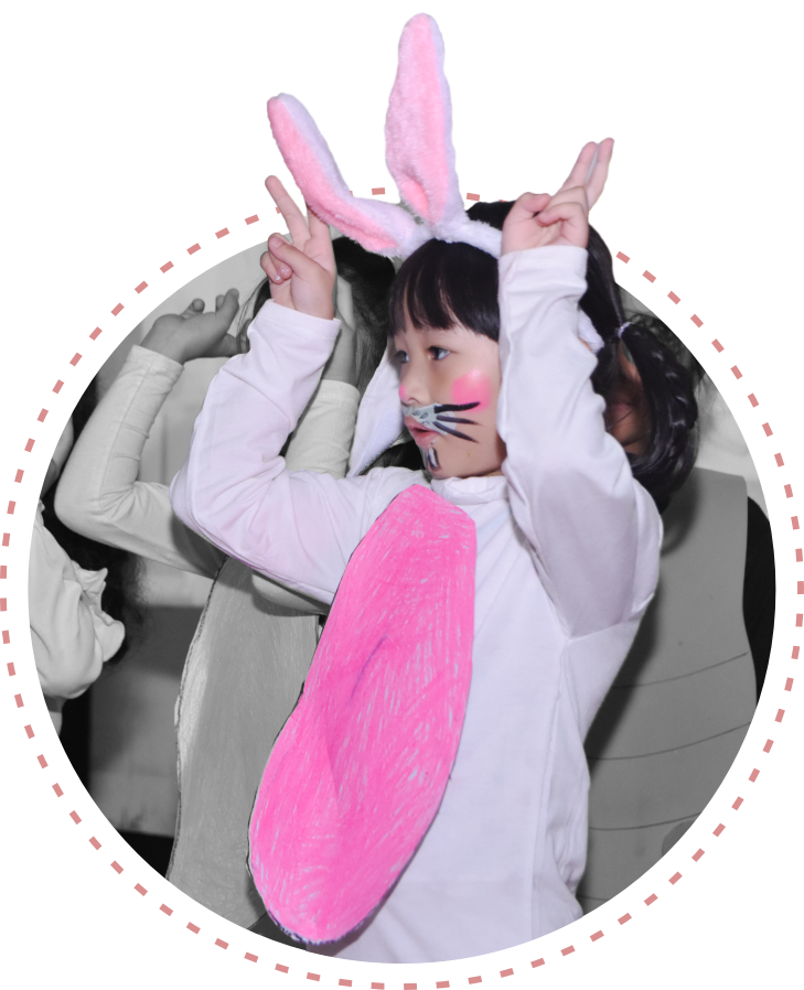 A student of Early childhood Education Programme at Sekolah Victory Plus - The innovative International Baccalaureate School In Indonesia is posing while wearing a rabbit costume