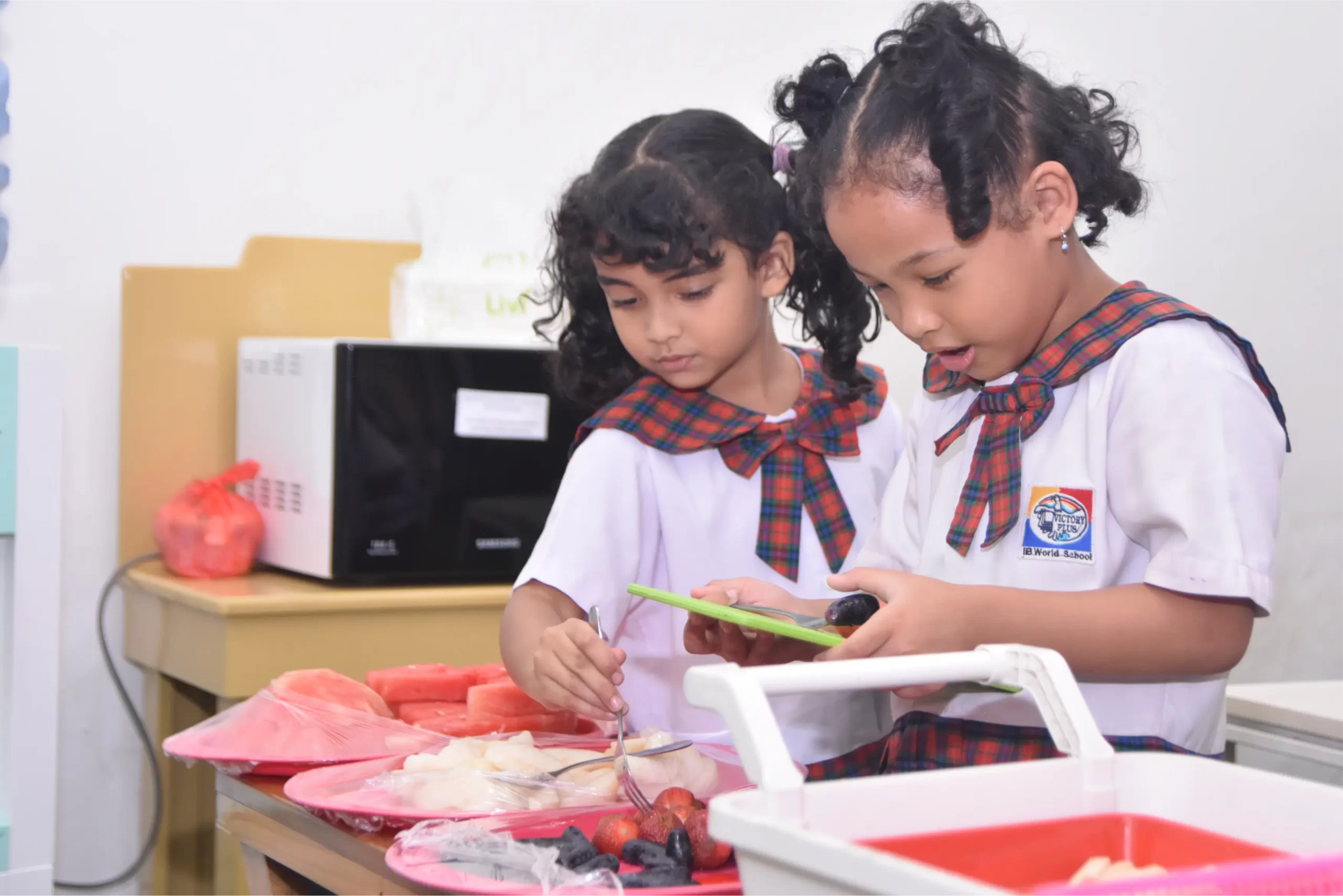 two students of early childhood education programme from Sekolah Victory Plus - The leading International Baccalaureate School in Indonesia are studying inside the classroom