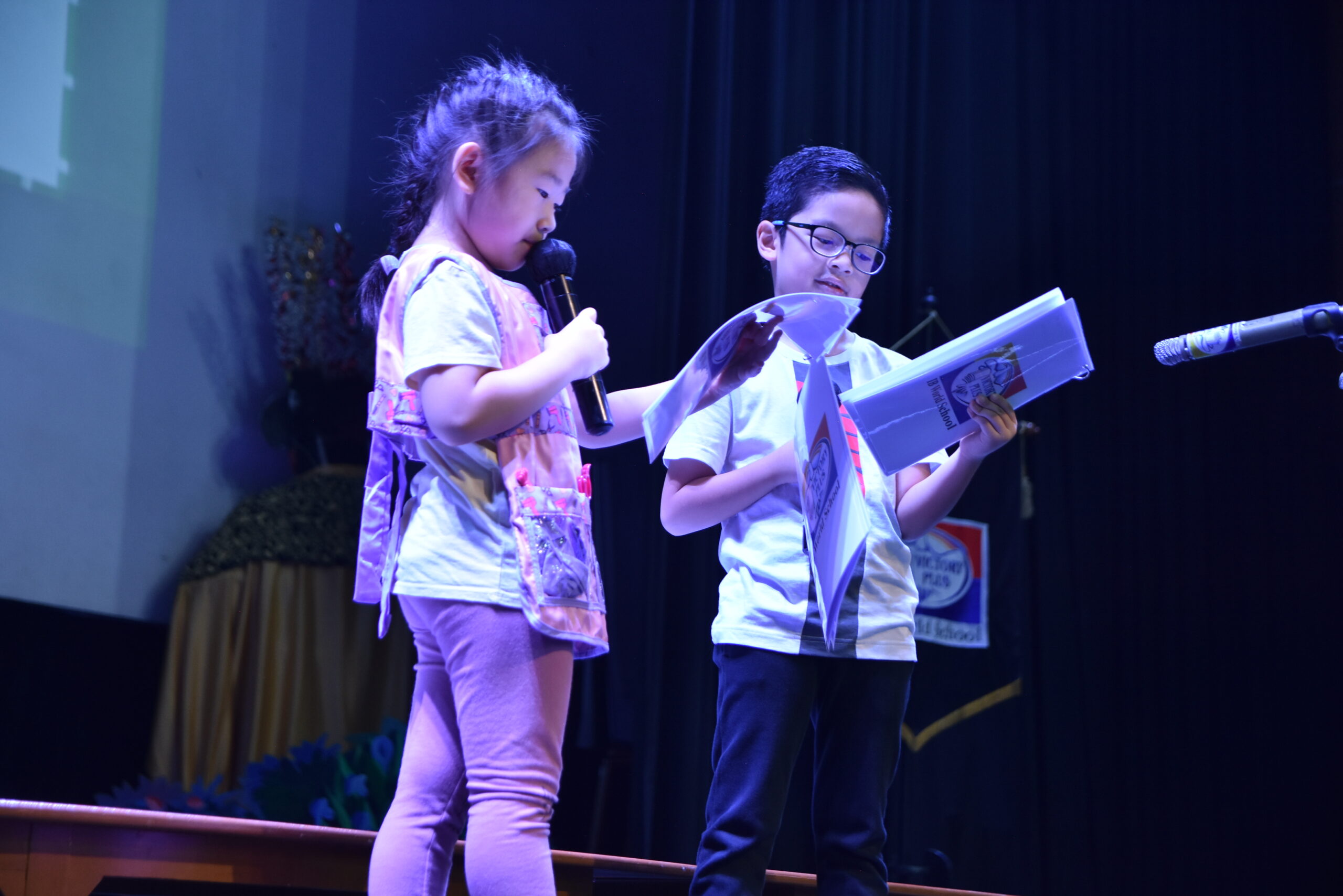 two students of early childhood education programme from Sekolah Victory Plus - The leading International Baccalaureate School in Indonesia are talking on the stage