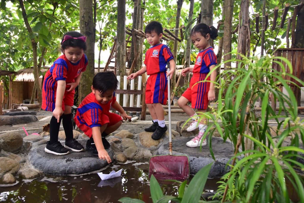 Four students of Sekolah Victory Plus - a school with IB Curriculum are playing at the Outdoor Learning Spaces
