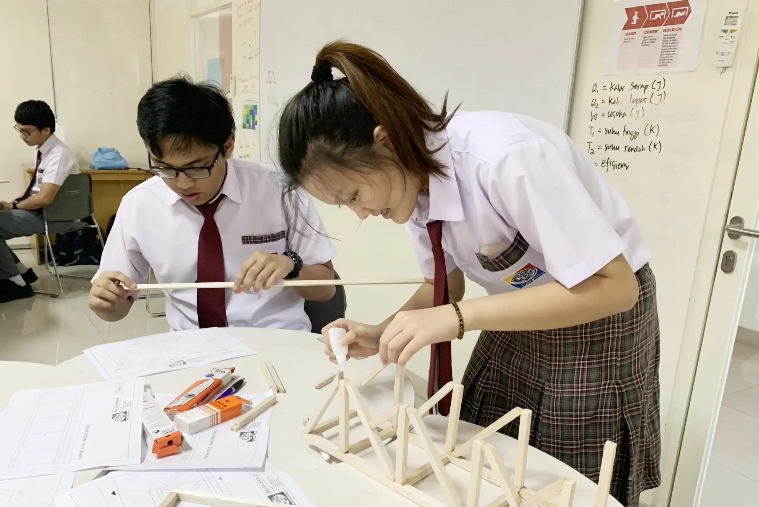 Two IB Middle years programme students are crafting in their class